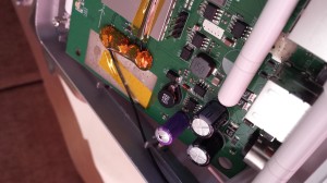 Side view of swollen capacitor on Asus RT-N16.